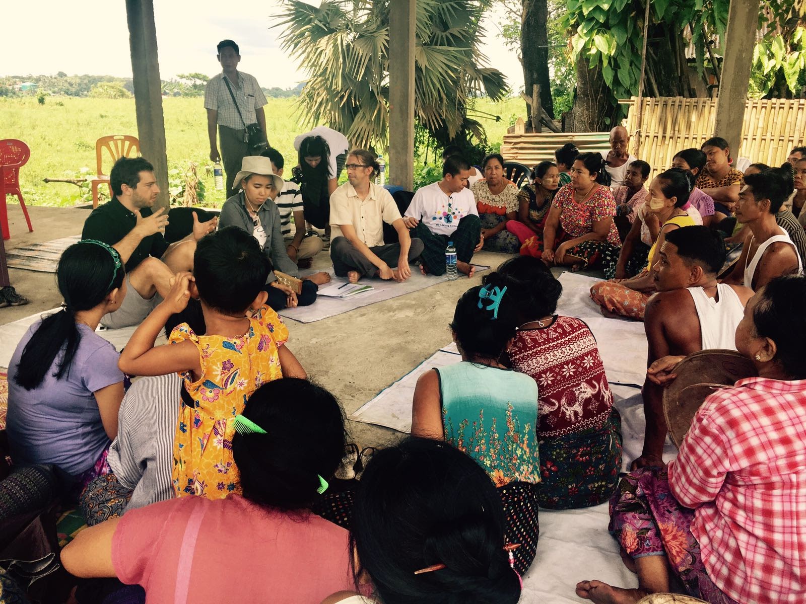 Lindsey Jones seated with community members during consultations in Hpa-An, Myanmar, in 2018, as part of fieldwork on household resilience to flooding in post-conflict areas.